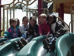 picture of students on new playground equipment