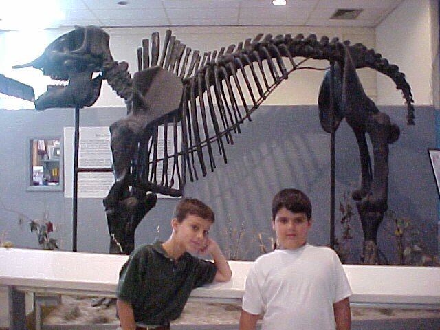 picture of students with dinosaur skeleton