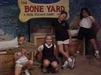 picture of students in fron t of bone yard sign